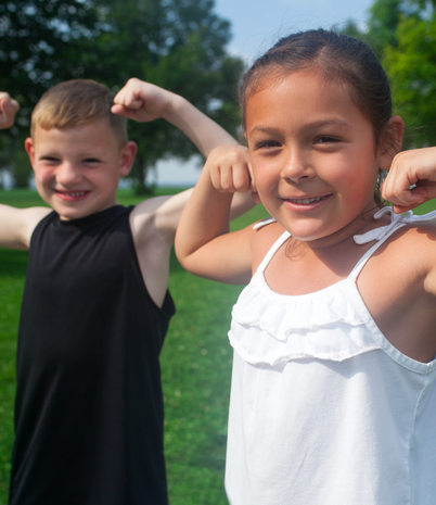 girl and boy flexing arms