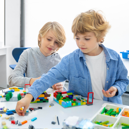 two children building with legos