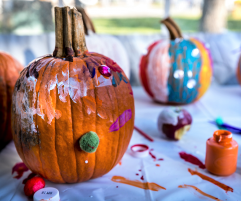 orange pumpkins with paint and decorations