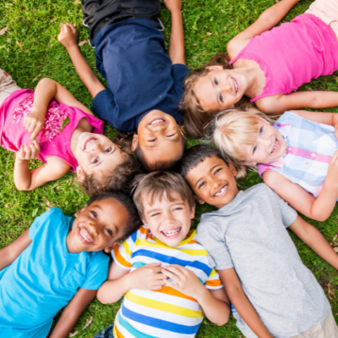 children laying in grass