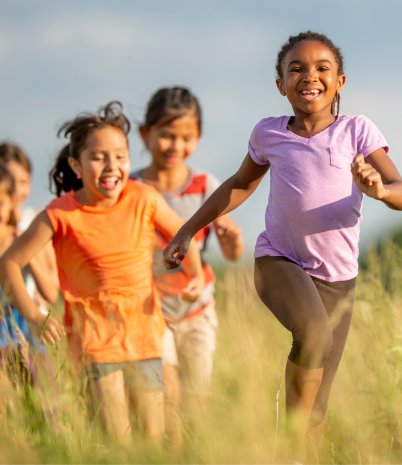 children running in tall grass