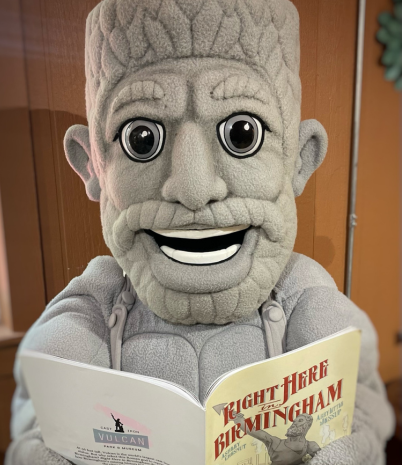 vulcan costume mascot reading a book