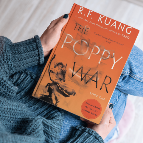 Woman reads The Poppy War by R.F. Kuang