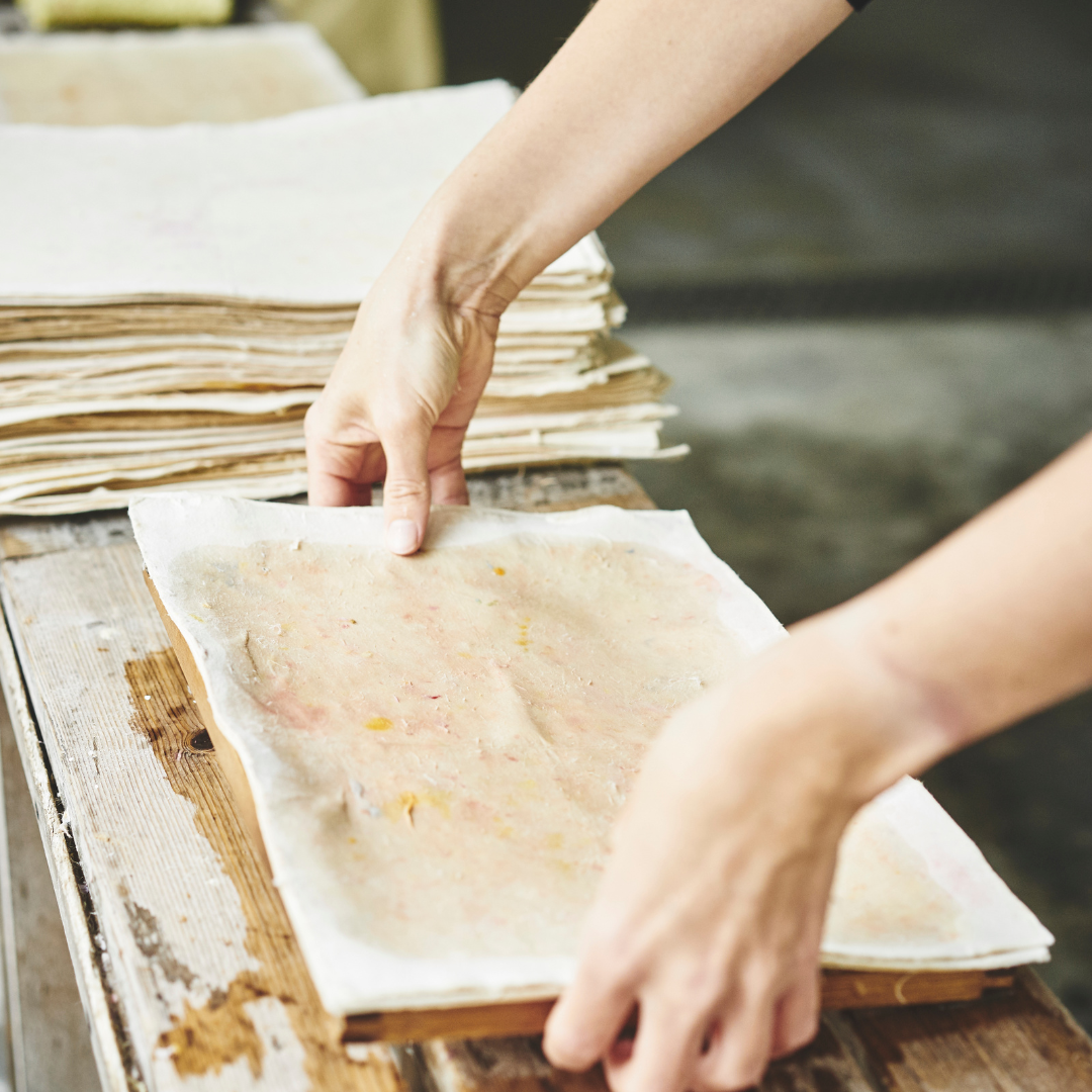 Person working with a deckle frame