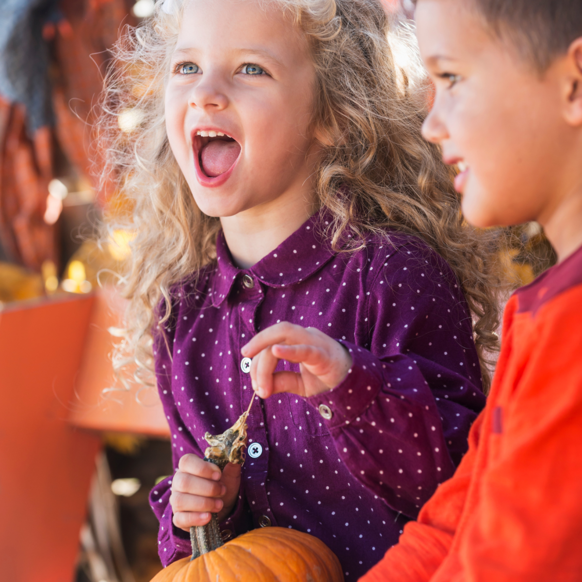 Boy and girl holding a pumpkin